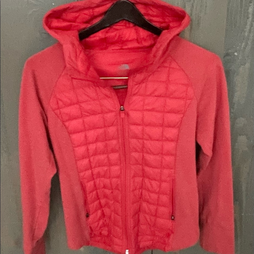 stylish orange zip up north face ski jacket.